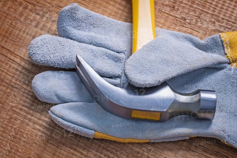 Claw hammer on glove close-up