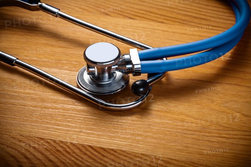 Close-up of classic stethoscope on wooden board medical concept