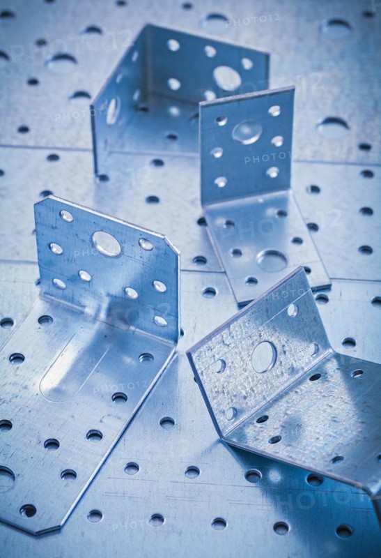 Metal bracket on perforated metallic background Design concept