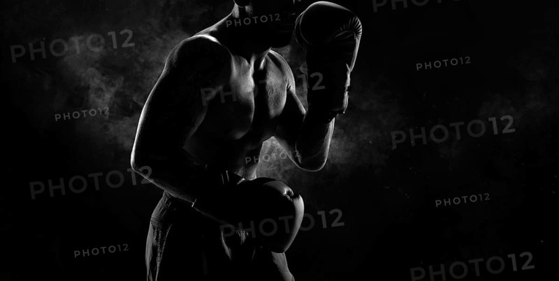 Noname image of a kickboxer on a dark background. The concept of mixed martial arts. MMA