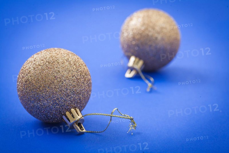 Golden Christmas baubles on a blue background