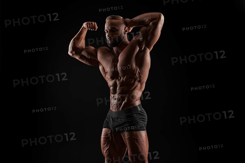 Handsome strong athletic men pumping up muscles. Workout