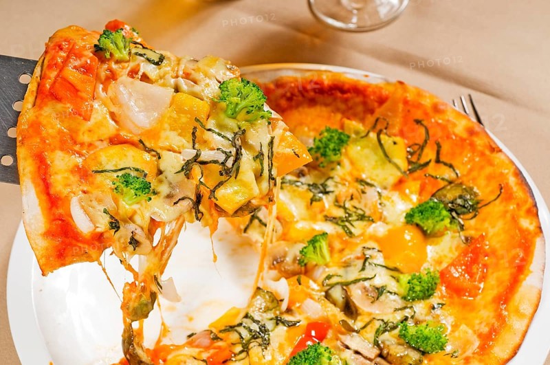 Fresh italian thin style vegetarian pizza with fresh mixed vegetables close up