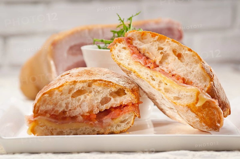 Italian ciabatta panini sandwich with parma ham and tomato
