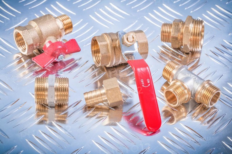 Brass nipple hose connectors equal tee check water valves on channeled metal plate plumbing concept