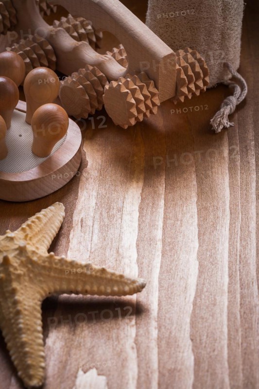 Massager starfish and scrubbing loofah on pine vintage wood background sauna concept
