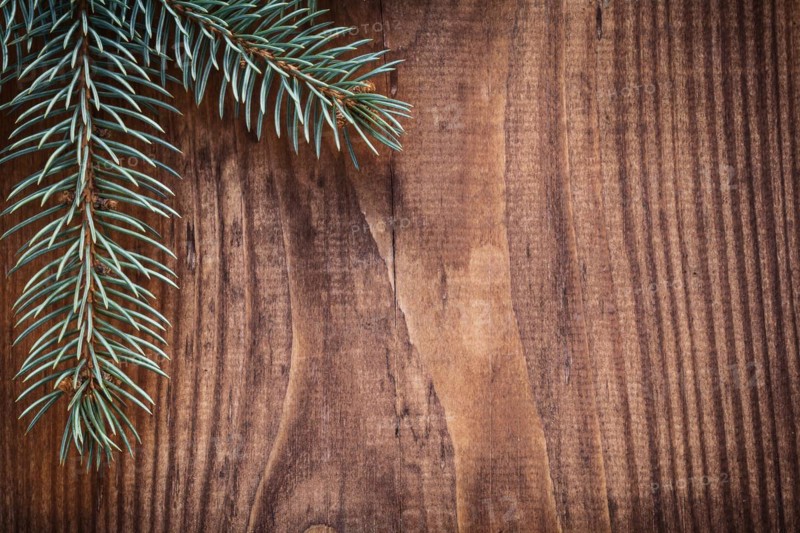 Copyspace Christmas background branches of fir tree on old wooden board horizontal version