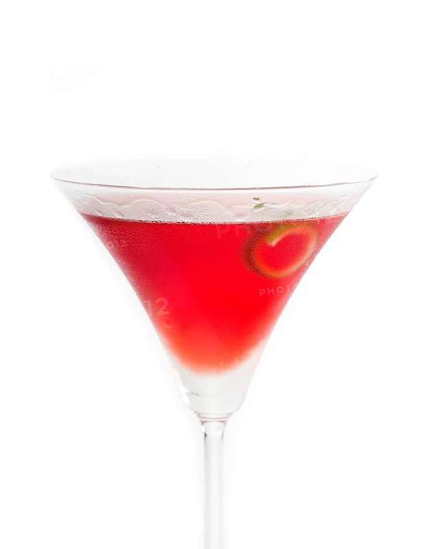 Cosmopolitan drink cocktail straight up on martini cup with lime peel isolated on white background