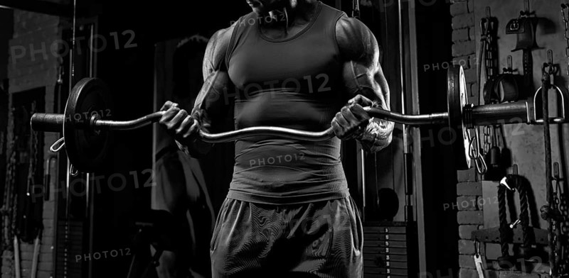No name strong athletic man pumping up muscles