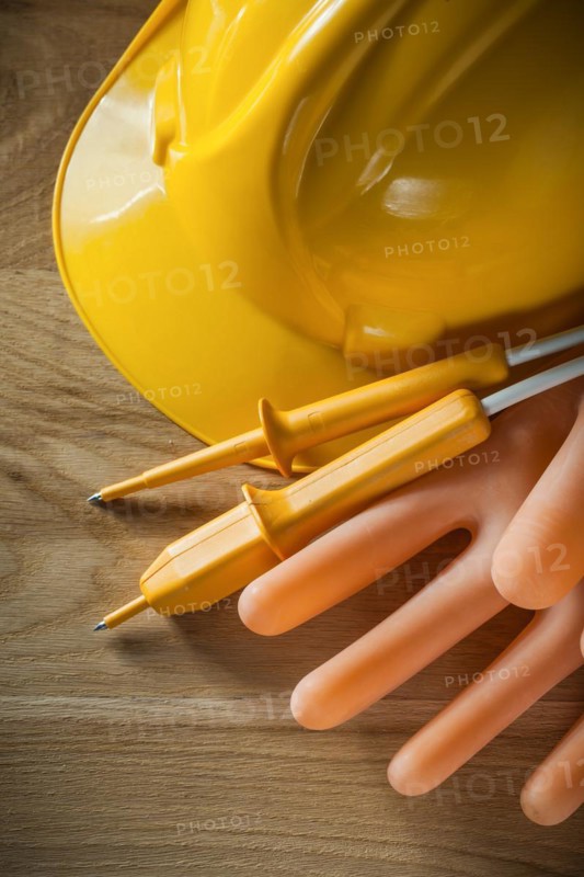 Electric tester hard hat dielectric gloves on wood board