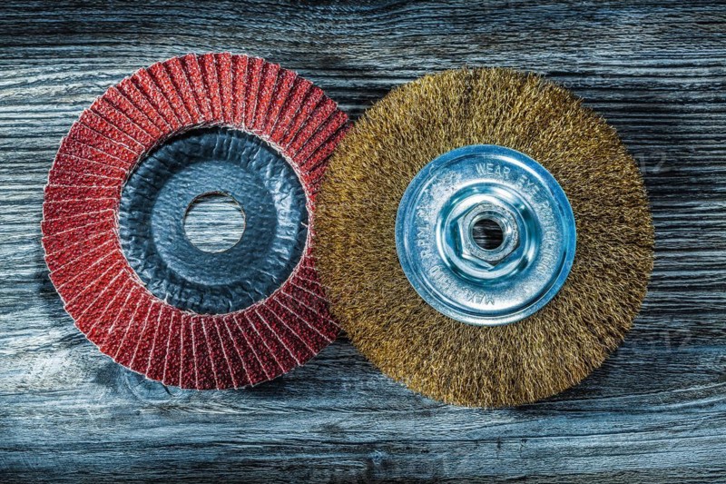 Abrasive disc wire brush on vintage wooden board
