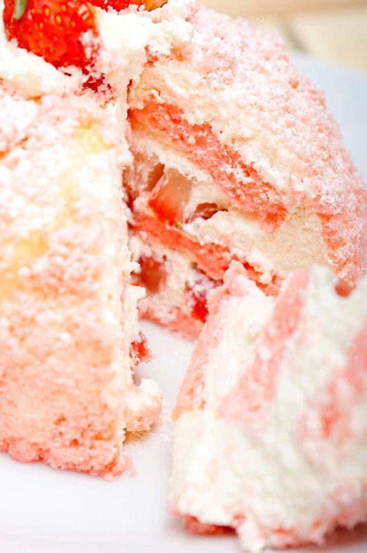 Fresh pink strawberry and whipped cream dessert macro close up