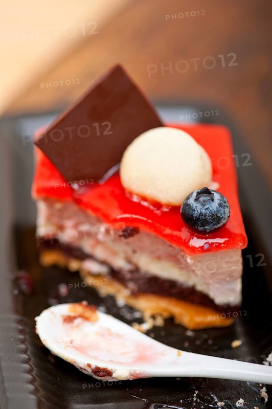 Fresh strawberry yogurt mousse with macaroon and blueberry on top
