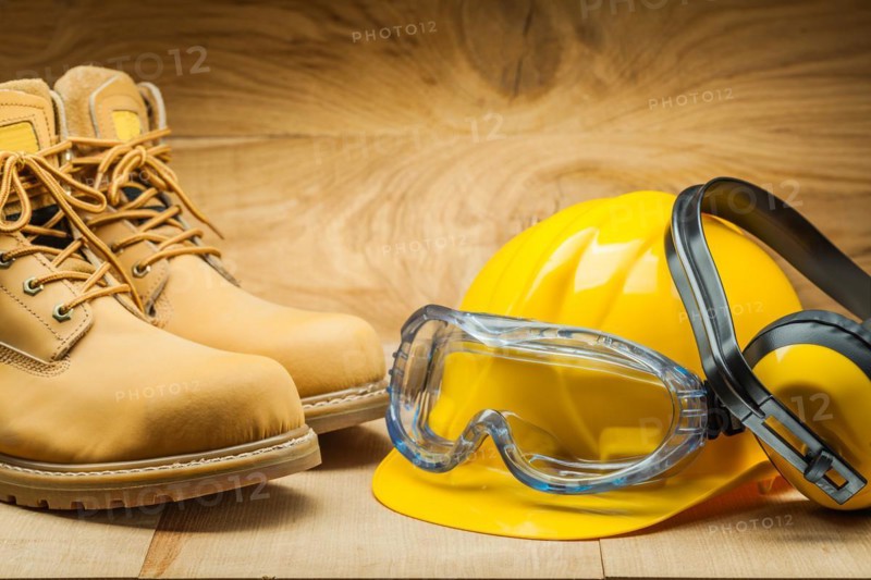 Working tools. construction concept. yellow construction helmet earphones working boots