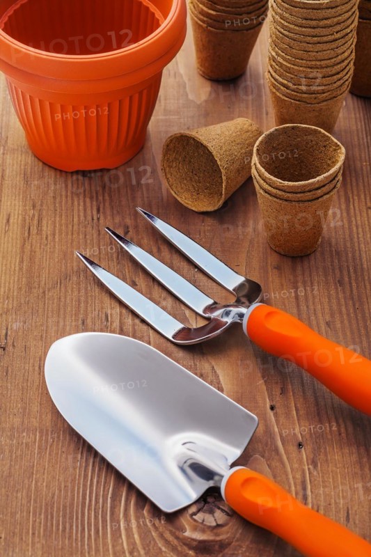 Gardening tools and pots on wooden boards