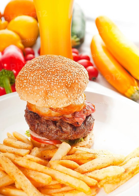 Classic american hamburger sandwich with onion rings and french fries