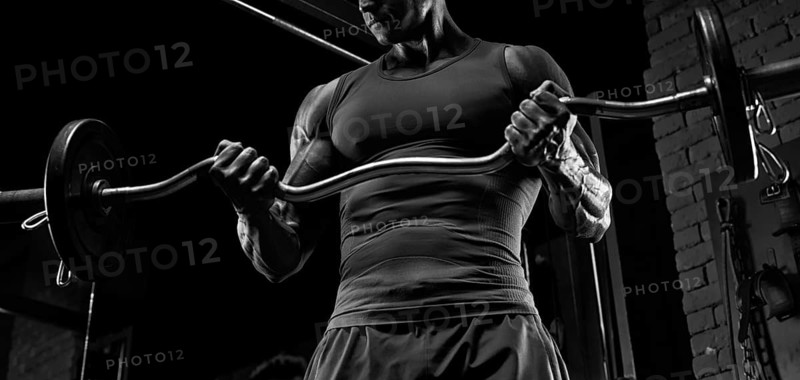No name strong athletic man pumping up muscles