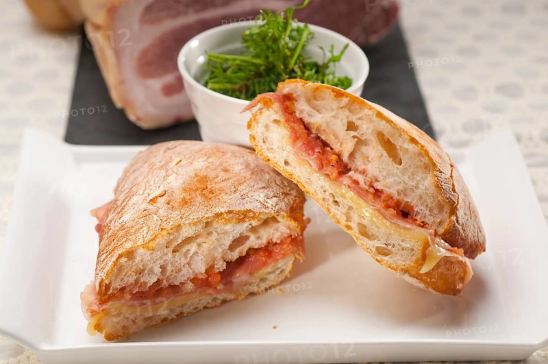 Italian ciabatta panini sandwich with parma ham and tomato