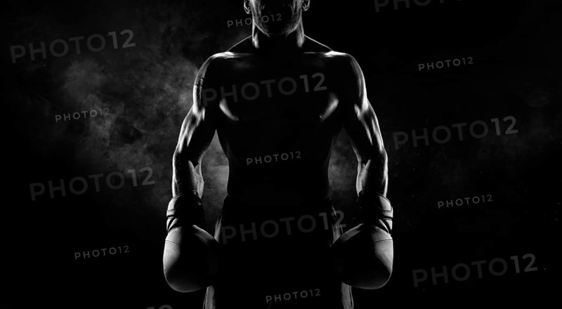 Noname image of a kickboxer on a dark background. The concept of mixed martial arts. MMA