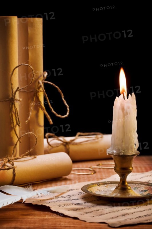 Burning candle and antique items