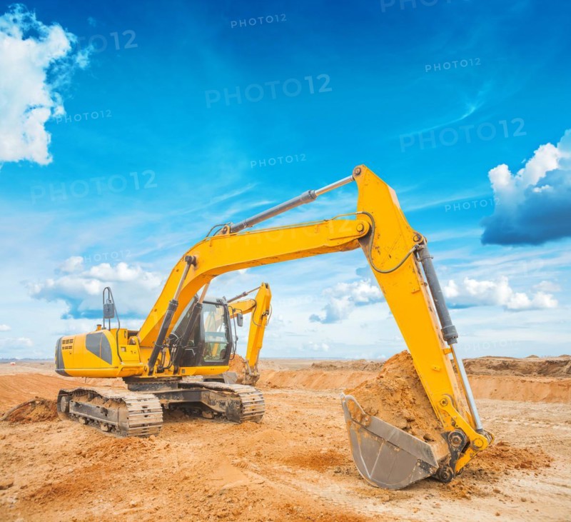 Excavator on construction site and sky background