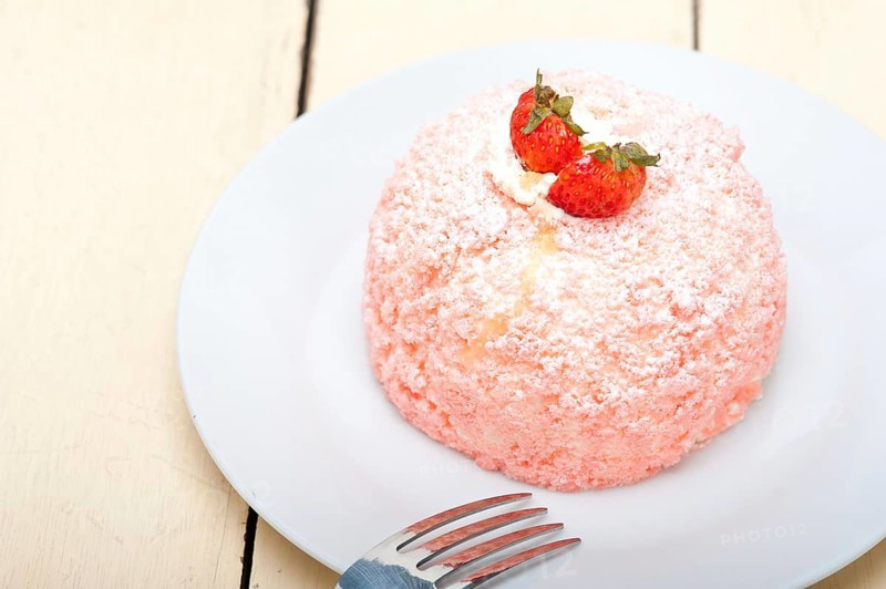 Fresh pink strawberry and whipped cream dessert macro close up