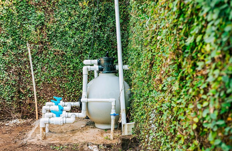 Home swimming pool filter and treatment plant installed. Pool pump with sand filter installed. Pool purification and maintenance system