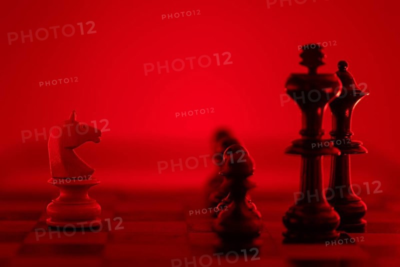 Chess pieces illuminated in a red light