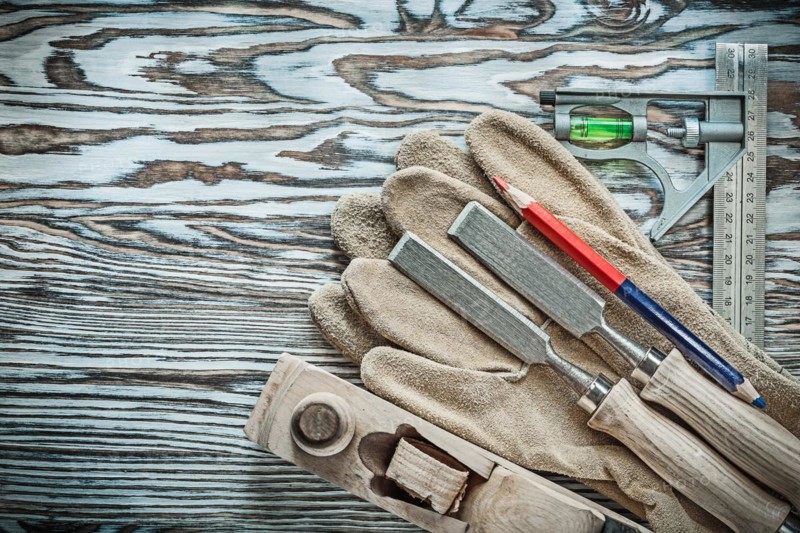 Set of carpenter tools on wooden board