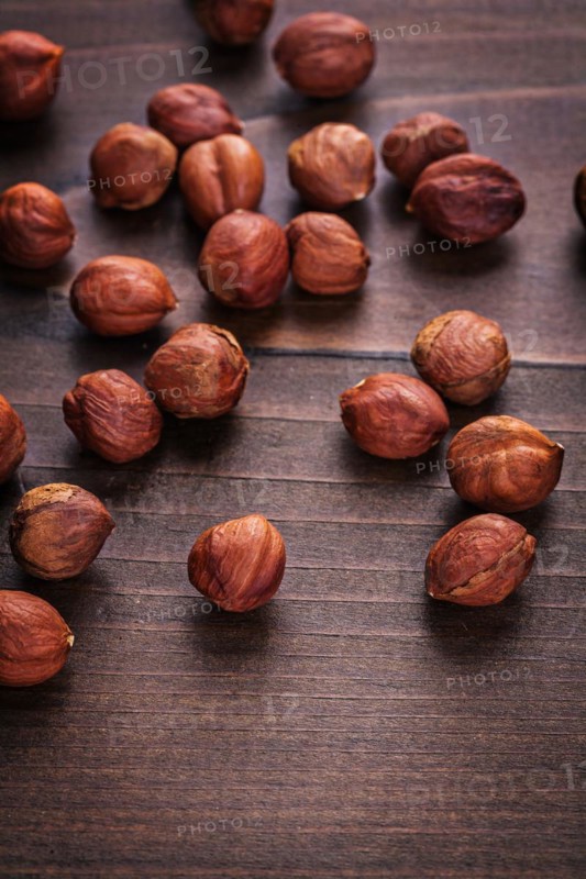 Hazelnut kernels on vintage wooden board Food and drink concept
