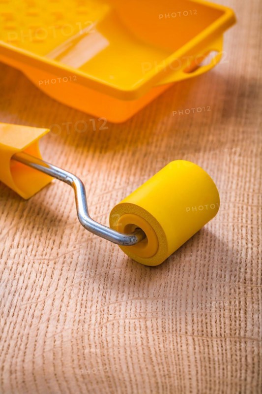 Colour roller tray on wooden board