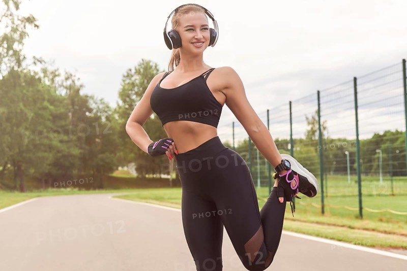 Charming girl does a workout in the park. The concept of a healthy lifestyle. Sports Equipment. Fitness style advertisement. Mixed media