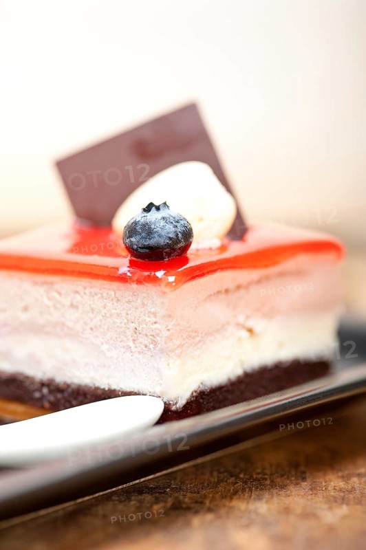 Fresh strawberry yogurt mousse with macaroon and blueberry on top