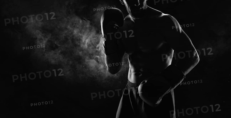 Noname image of a kickboxer on a dark background. The concept of mixed martial arts. MMA