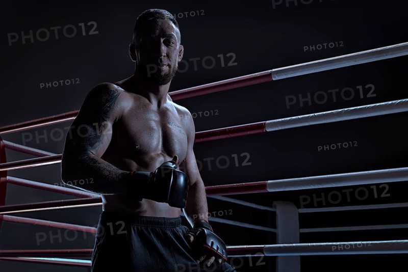 Kickboxer showing thumbs up standing near the ring. Sports competitions. Fight night. The concept of mixed martial arts. MMA