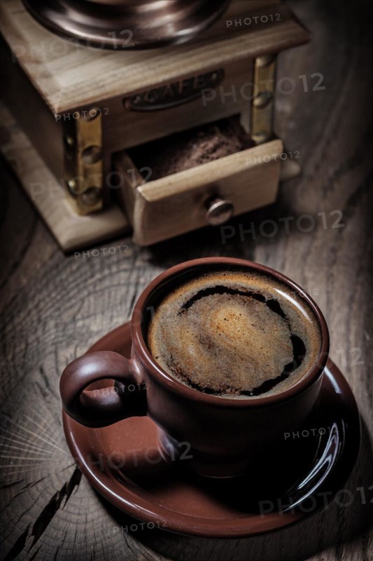 Brown coffee cup and mill close up view