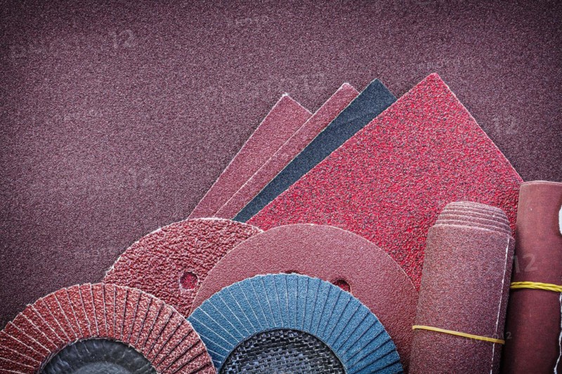 Heap of abrasive materials on glass-paper