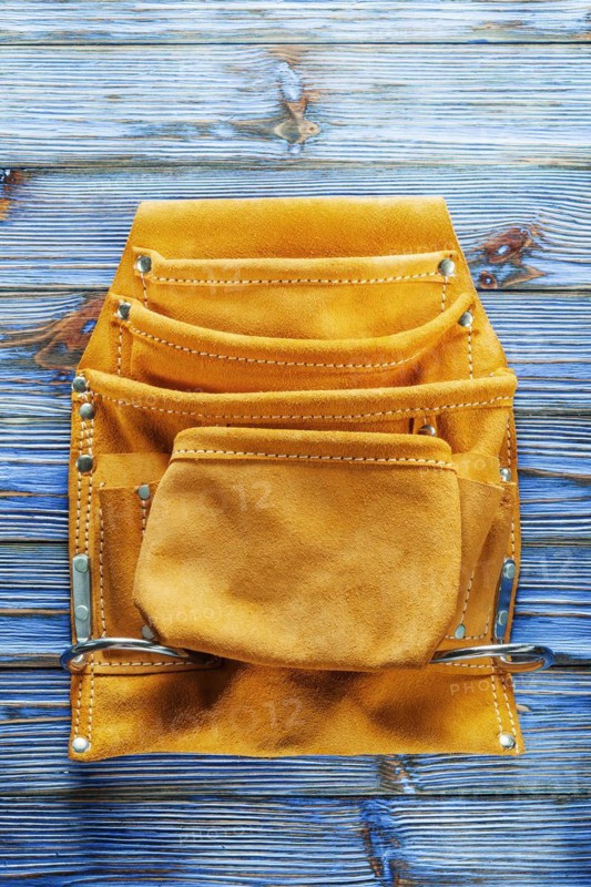Leather tool belt on vintage wooden board