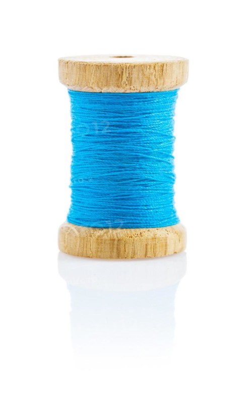 A small wooden spool with blue thread