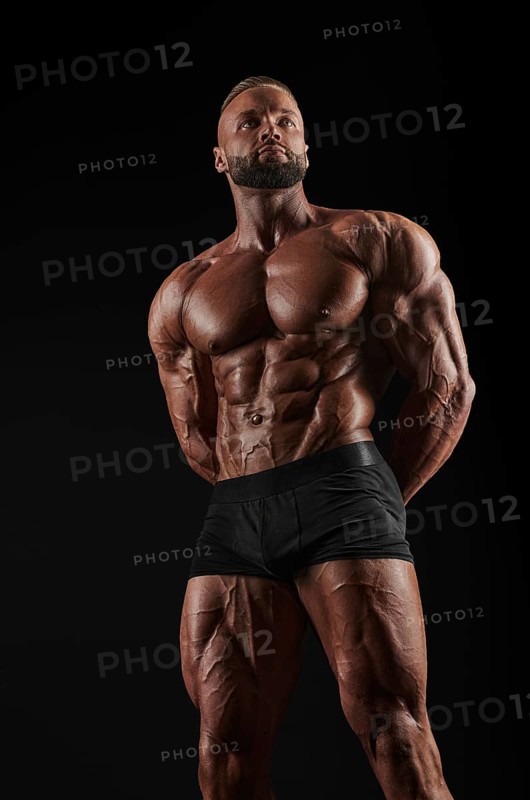 Handsome strong athletic men pumping up muscles. Workout