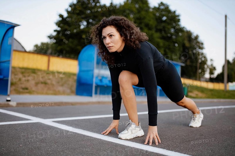 Curly girl runner is engaged in athletics