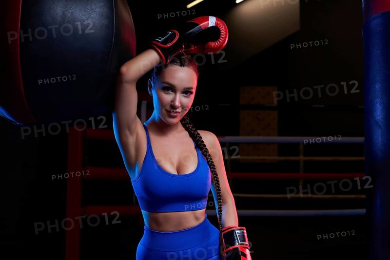 Woman boxer in red gloves. Sports concept