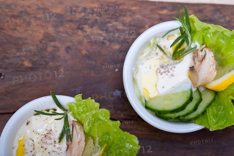 Fresh organic garlic cheese dip salad on a rustic table