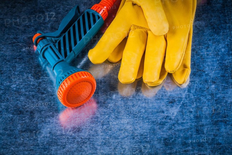 Set of leather protective gloves and hose nozzle agriculture concept