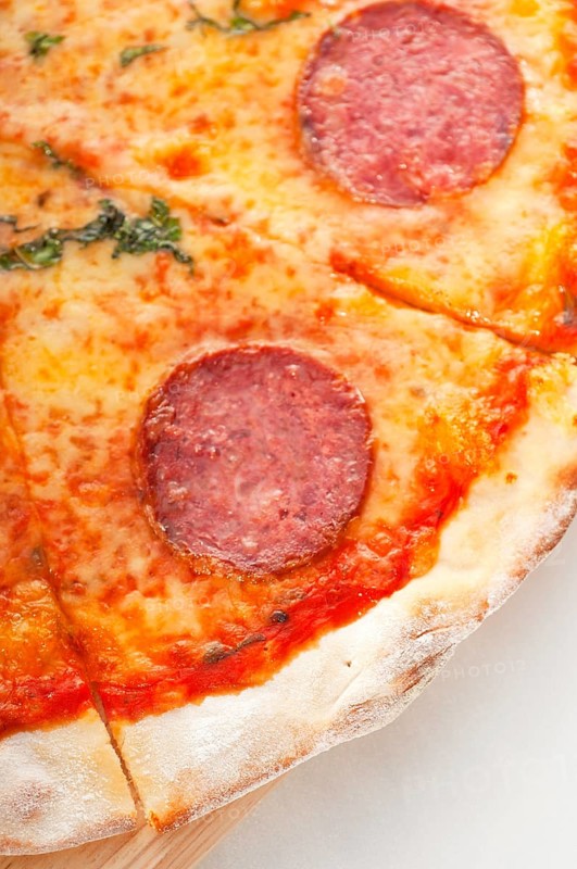 Italian original thin crust pepperoni pizza extrene close up