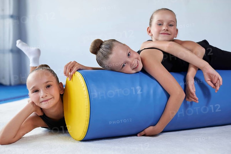 Image of a group of little girls in the gym after a workout. Gymnastics concept. Mixed media