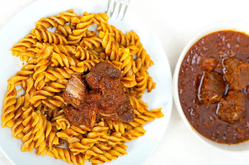 Fusilli pasta al dente with neapolitan style ragu meat sauce very different from bolognese style