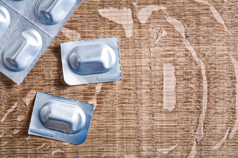 Medicinal pills on a wooden board