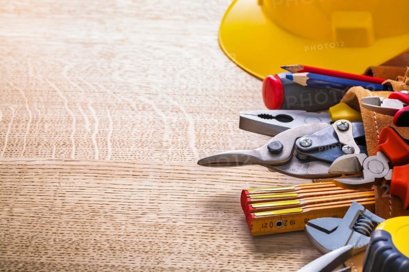Organised copy room Hammer Tape measure Wrench Pliers Cutter Pencil in tool belt on wooden board