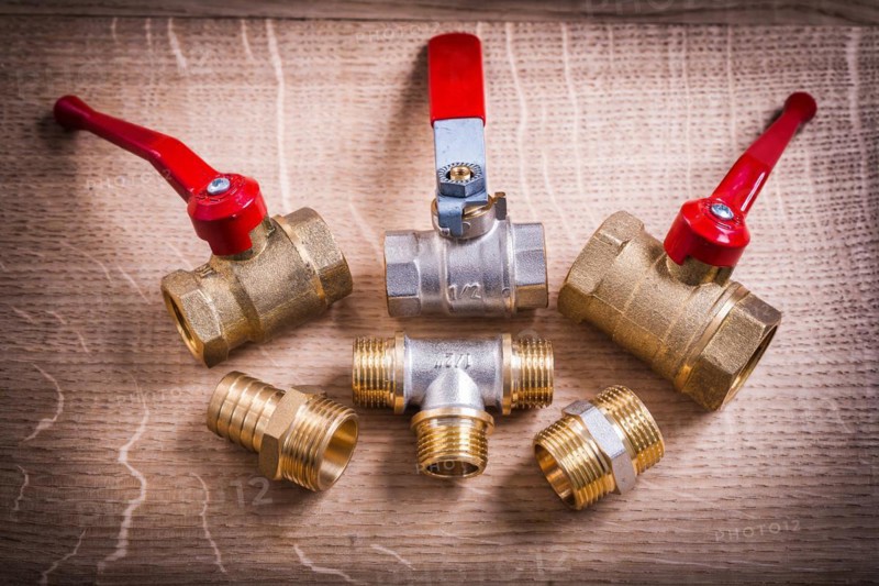 Composition Of Plumbing Tools Brass Pipe Connectors On Wooden Board